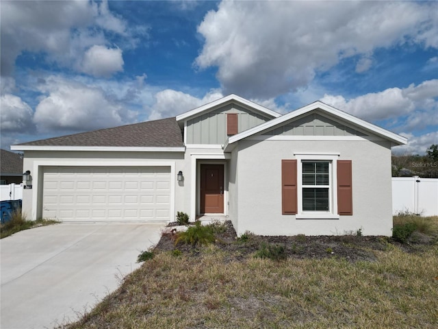 view of front of house featuring a garage and a front lawn