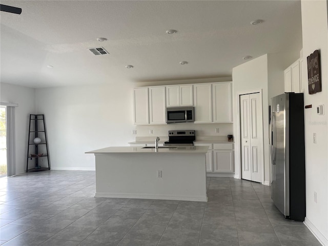 kitchen with white cabinetry, sink, a center island with sink, and appliances with stainless steel finishes