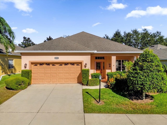 view of front of home featuring a front yard and a garage