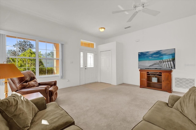 carpeted living room featuring ceiling fan