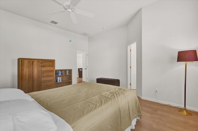 bedroom with light hardwood / wood-style floors and ceiling fan