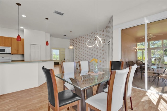 dining space with plenty of natural light, light hardwood / wood-style floors, and ceiling fan