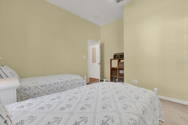 bedroom featuring carpet and vaulted ceiling