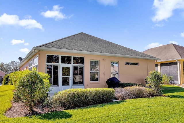 rear view of property with a lawn