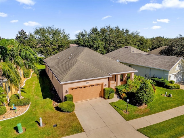 view of front facade with a front yard and a garage