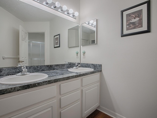 33236 Grand Cypress Way, Leesburg, FL 34748 - bathroom featuring double vanity and a shower with shower door