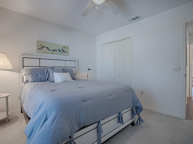 33236 Grand Cypress Way, Leesburg, FL 34748 - carpeted bedroom with a closet, a textured ceiling, ceiling fan, and baseboards