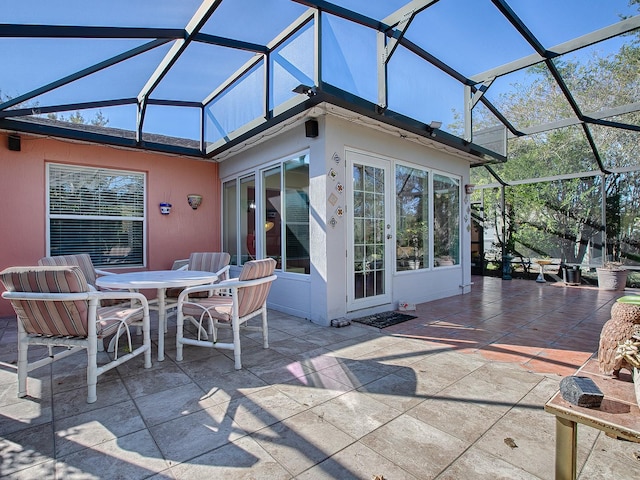 view of patio featuring glass enclosure