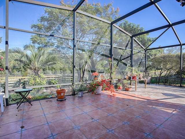 view of patio featuring a lanai