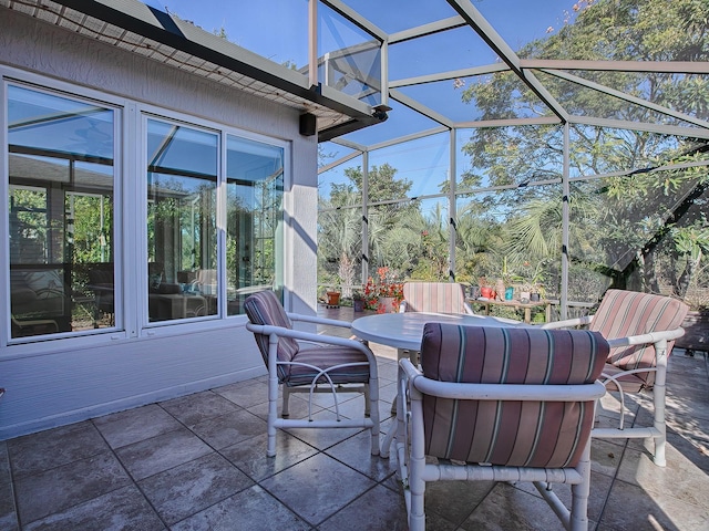 view of patio featuring glass enclosure