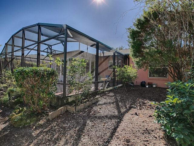 view of yard featuring glass enclosure