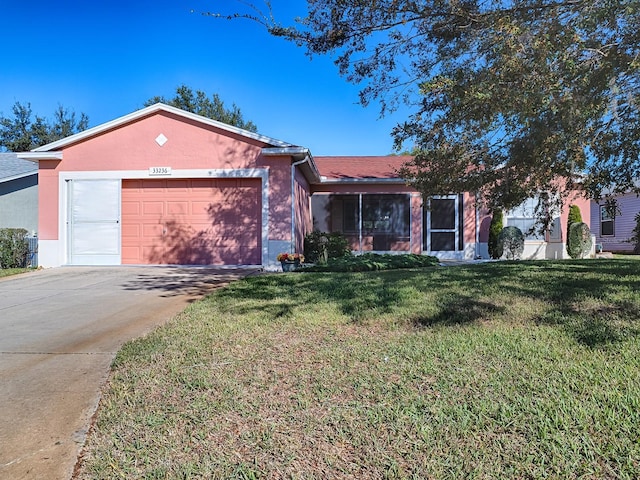 ranch-style home with a garage and a front lawn