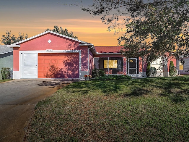 view of front of house featuring a lawn and a garage