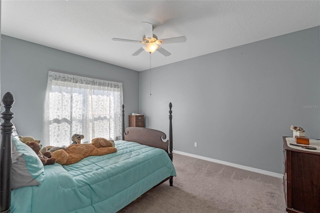 carpeted bedroom featuring ceiling fan and baseboards