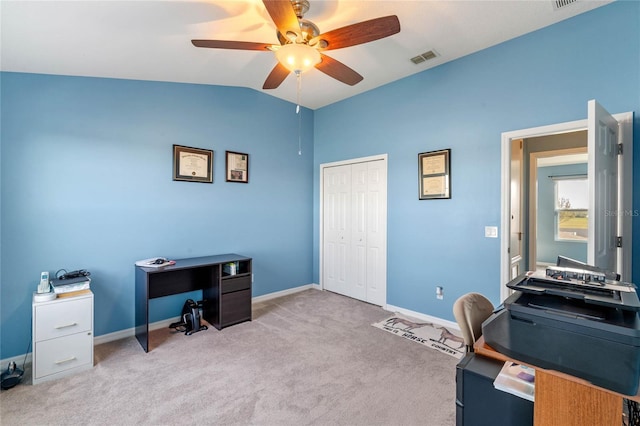 home office featuring lofted ceiling, visible vents, a ceiling fan, carpet flooring, and baseboards