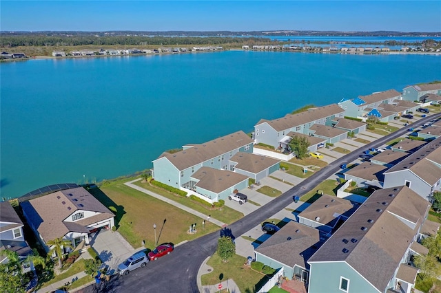 drone / aerial view with a residential view and a water view