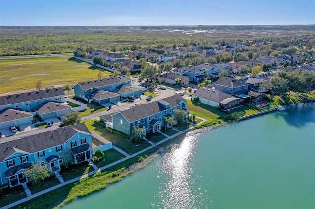 drone / aerial view featuring a residential view and a water view