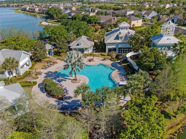 drone / aerial view featuring a water view and a residential view