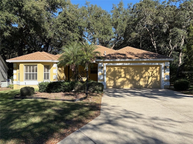 ranch-style house with a front yard and a garage