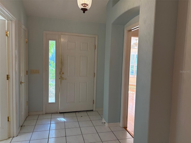 foyer entrance with a healthy amount of sunlight and light tile patterned flooring