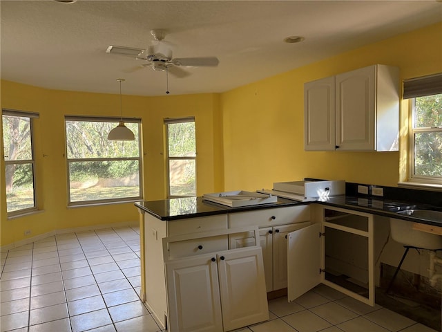 kitchen with white cabinets, ceiling fan, light tile patterned floors, and kitchen peninsula