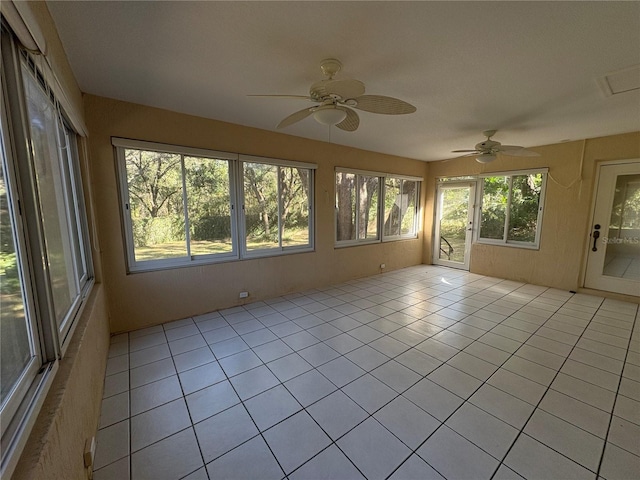 unfurnished sunroom with ceiling fan