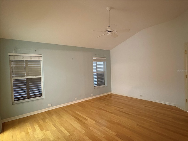 unfurnished room with ceiling fan, light wood-type flooring, and lofted ceiling