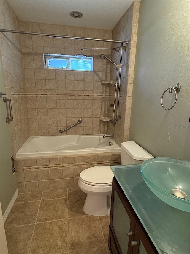 full bathroom featuring tile patterned flooring, vanity, toilet, and tiled shower / bath