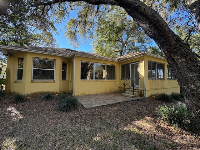 back of property with a patio