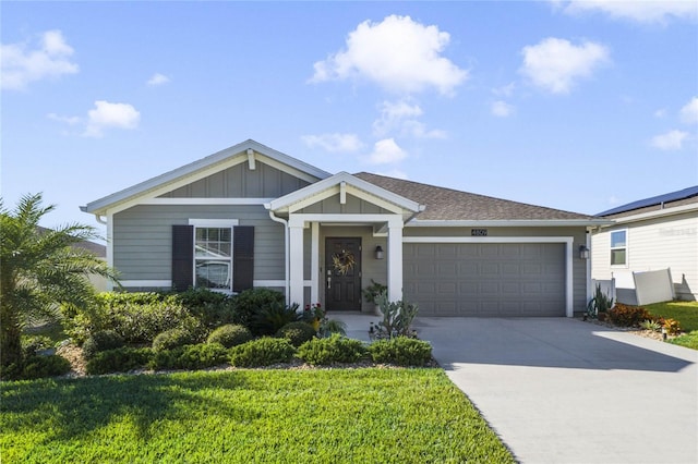 view of front of house featuring a garage and a front lawn