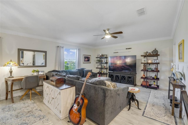 living room featuring light hardwood / wood-style floors, ceiling fan, and crown molding