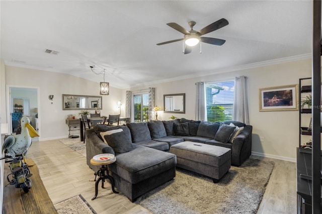 living room with ceiling fan with notable chandelier, light hardwood / wood-style floors, and ornamental molding