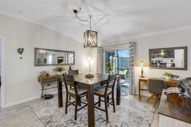 dining room featuring light wood-type flooring, crown molding, and vaulted ceiling