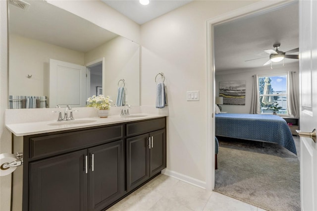 bathroom featuring tile patterned flooring, vanity, and ceiling fan