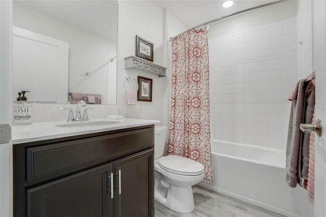 full bathroom with hardwood / wood-style floors, vanity, toilet, and shower / bathtub combination with curtain