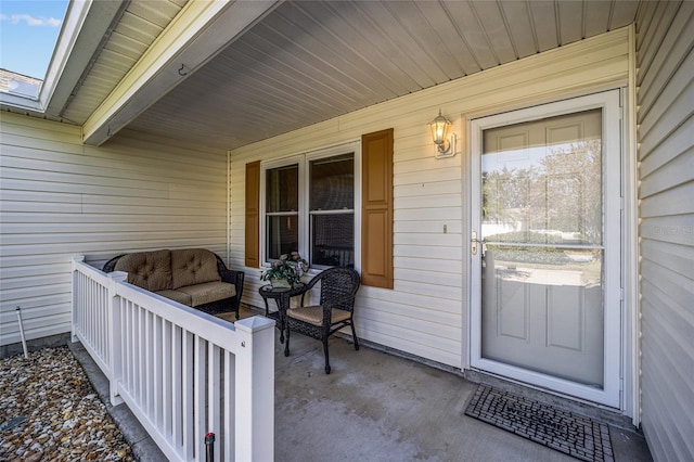 view of exterior entry featuring covered porch