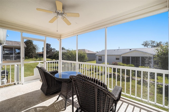 sunroom featuring ceiling fan