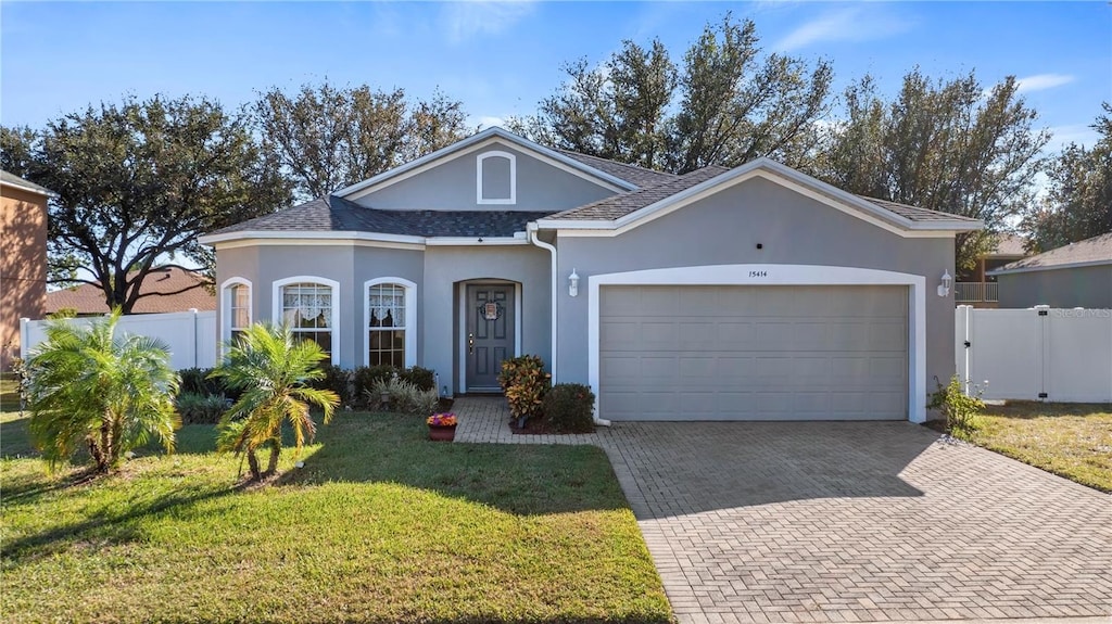 ranch-style house with a front yard and a garage