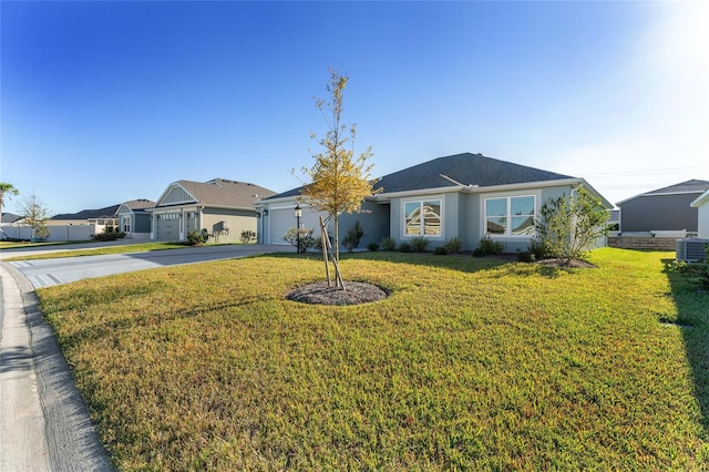 single story home featuring a garage and a front lawn