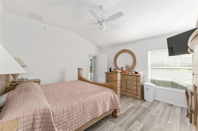 bedroom with ceiling fan, vaulted ceiling, and light wood-type flooring