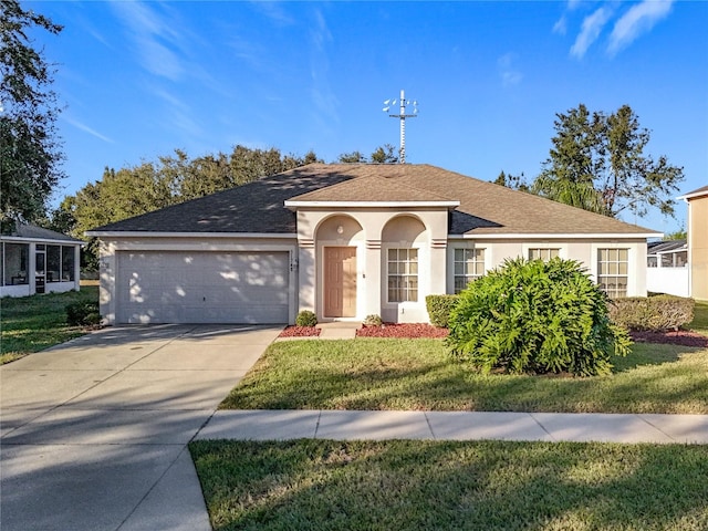 view of front of home featuring a front yard and a garage