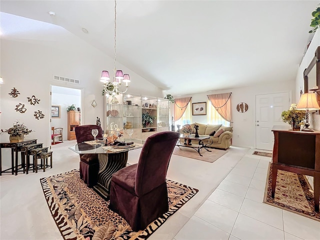 tiled dining area with high vaulted ceiling and an inviting chandelier