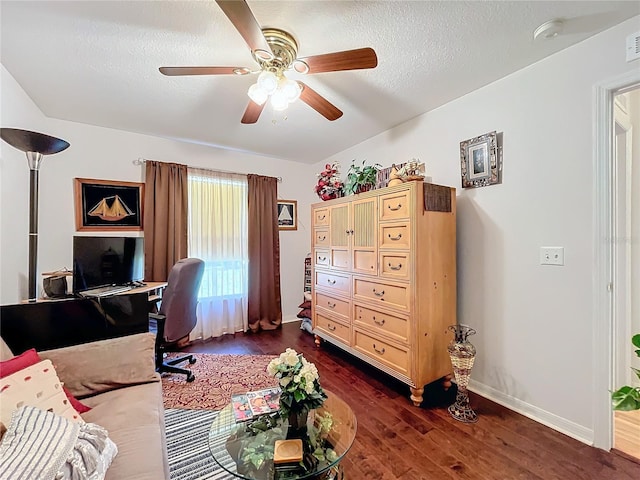 office area featuring ceiling fan, dark hardwood / wood-style flooring, and a textured ceiling