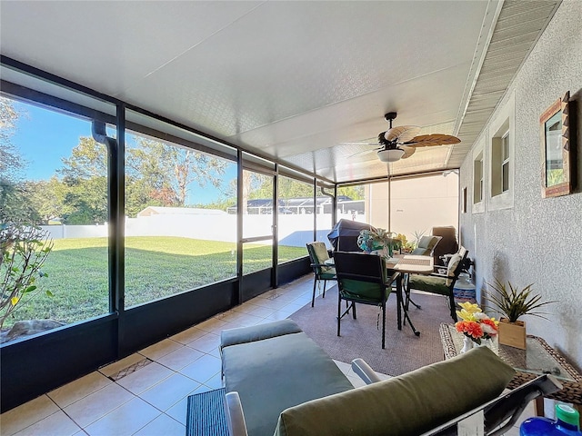 sunroom / solarium featuring ceiling fan