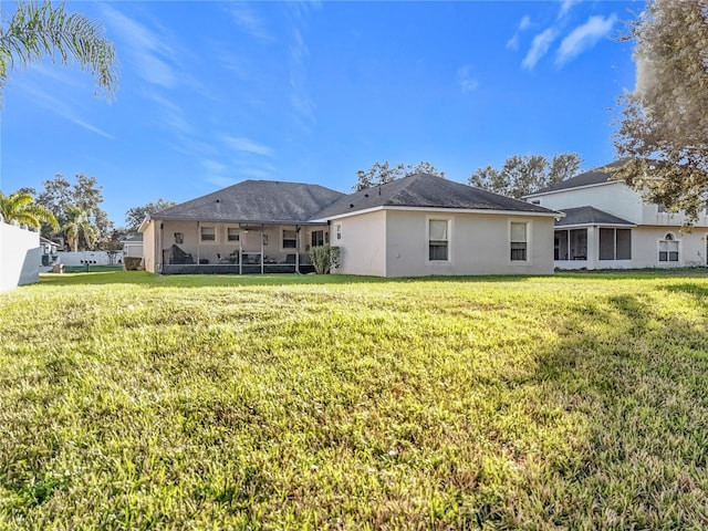 back of property featuring a yard