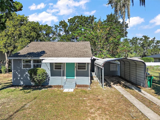 bungalow-style house with a front lawn and a carport