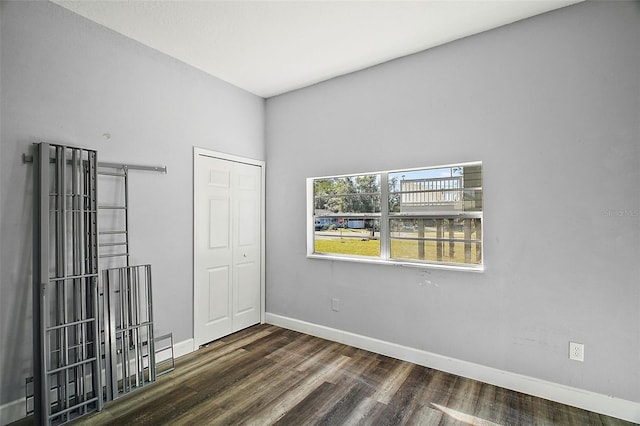 unfurnished room with dark hardwood / wood-style floors