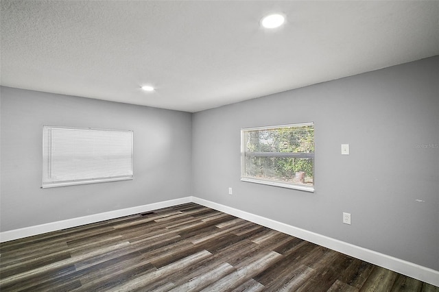 empty room featuring dark hardwood / wood-style flooring