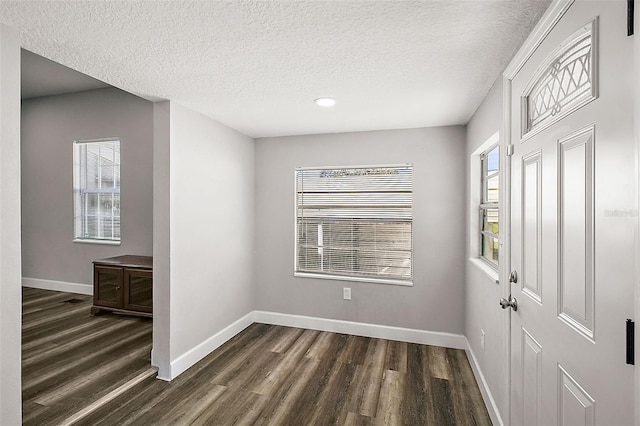 entrance foyer featuring dark hardwood / wood-style flooring and a textured ceiling