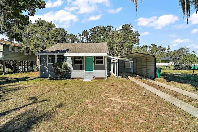 bungalow-style house featuring a carport and a front yard